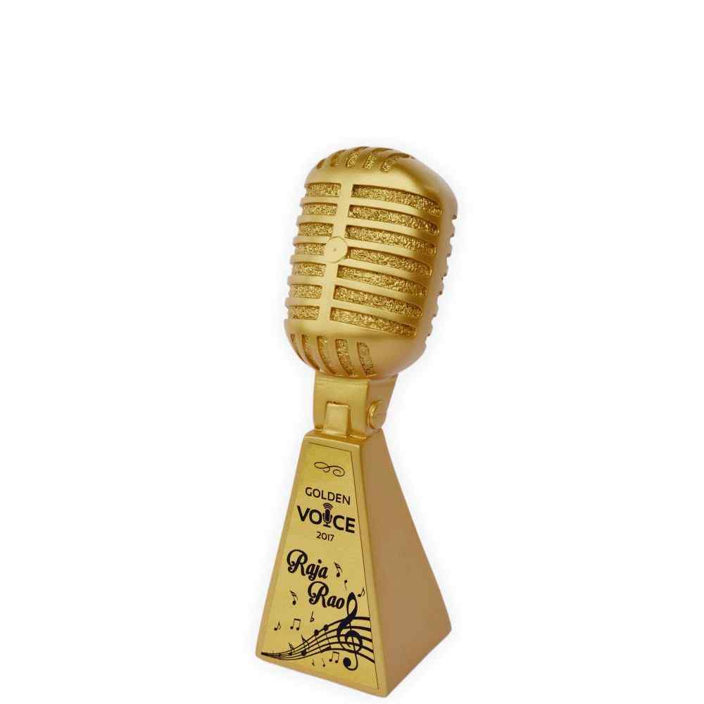 A golden microphone trophy with a sign reading "The Golden Voice"