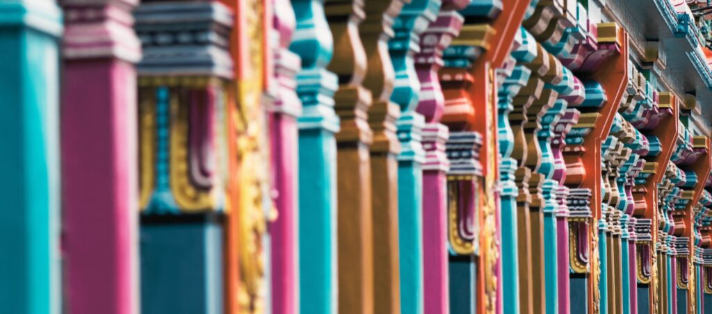 A row of colorfully painted wooden pillars