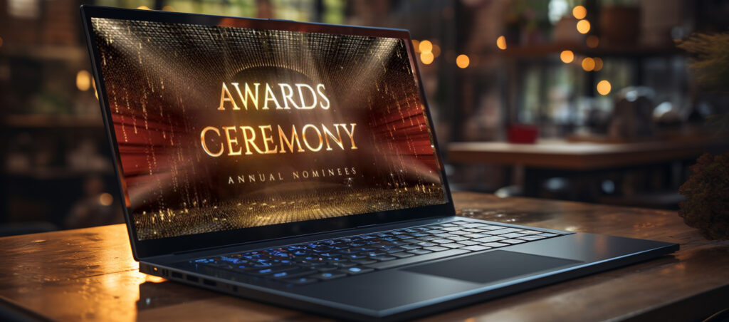 A laptop with the words awards ceremony on it kept on a table