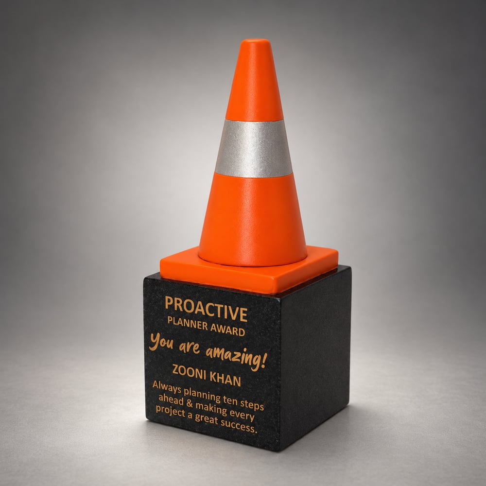 Orange traffic cone shaped resin fun award at work with and antique silver band on a personalised black base