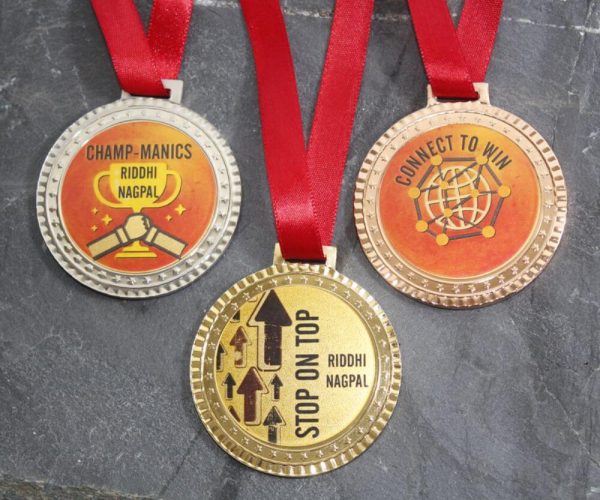 Three medals: gold, silver, and bronze, each with unique designs,