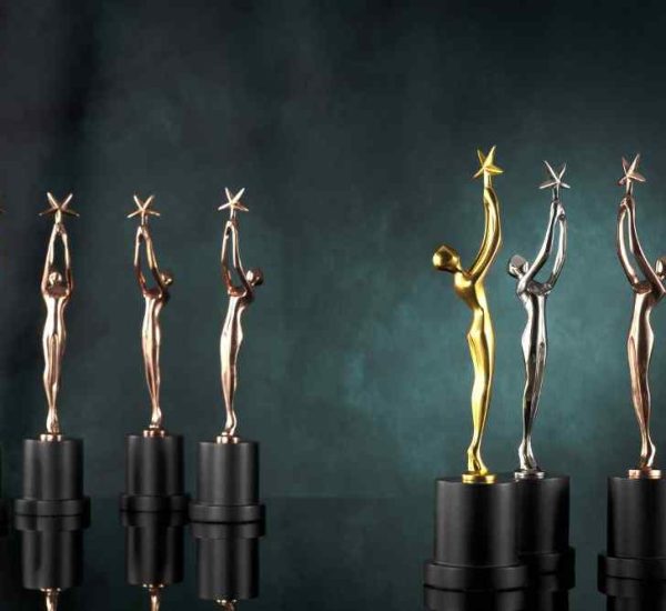 Array of gleaming metal trophies with a black base showcased in a row