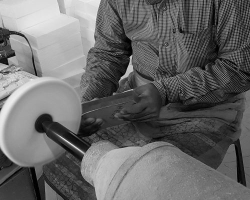 Skilled craftsman shaping glass.