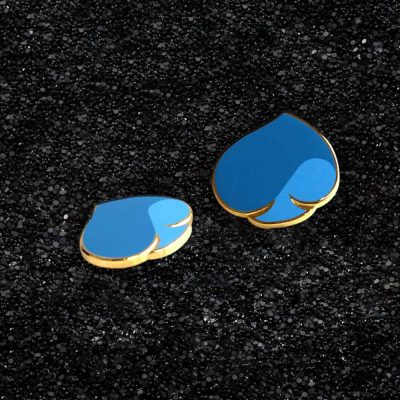 Two blue heart-shaped lapel pins with golden border