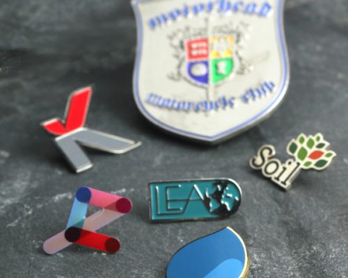 A collection of badges and pins displayed on a table