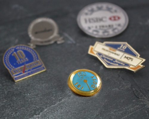 A collection of lapel pins and badges, showcasing