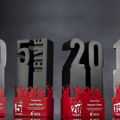 Beautiful heavy long service awards shaped in numbers of 5 years, 10 years, 15 years and 20 years showcase in an awards ceremony.